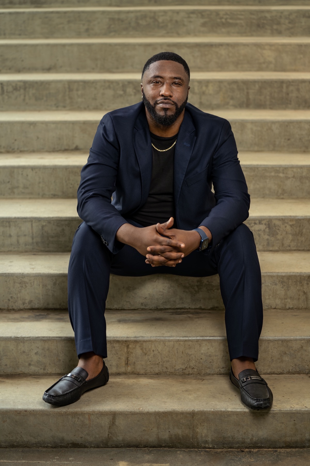 Marc Black, CEO, seated on concrete steps